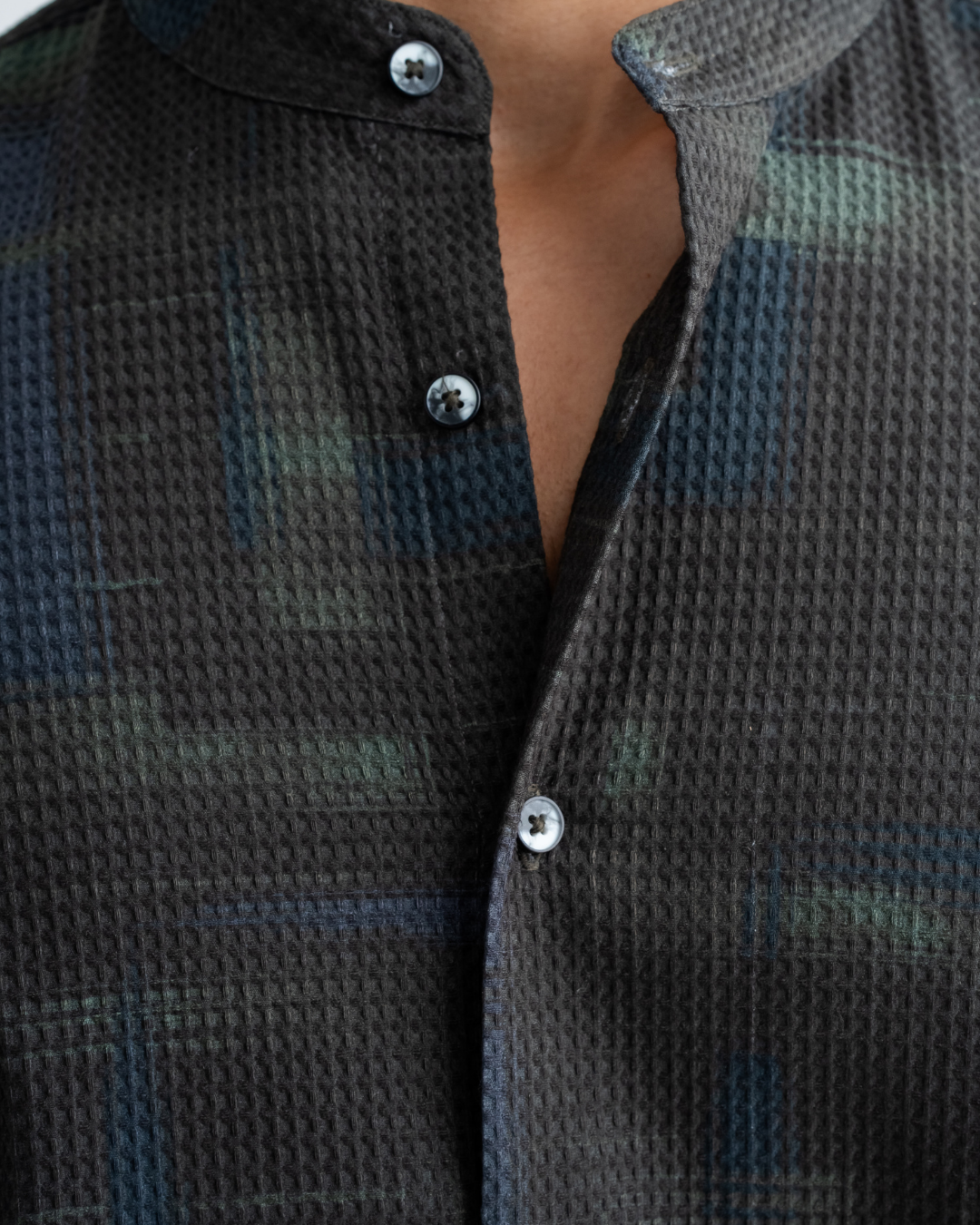 Close-up of a dark patterned shirt with buttons